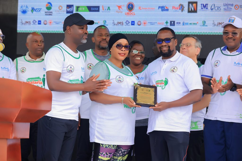 Board Chairman of Microhaem Scientifics, Prof. Bruce Kirenga, receiving an award from Hon. Hajjat. Aminah Mukalazi on behalf of Microhaem for the outstanding contribution towards Malaria Elimination